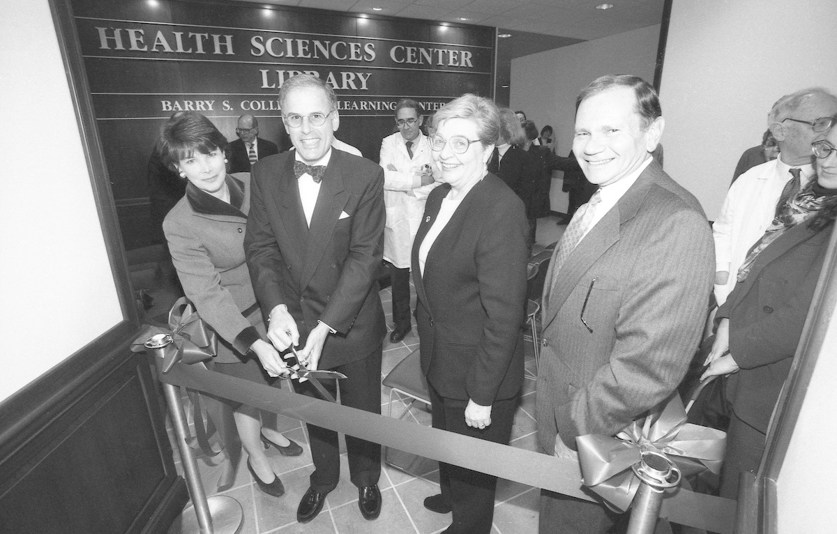 People at a library room dedication ceremony
